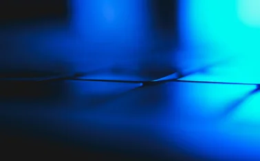 Abstract blue light and shadows creating 3D-rendered lines and geometric shapes