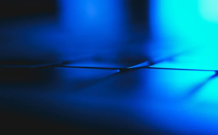 Abstract blue light and shadows creating 3D-rendered lines and geometric shapes